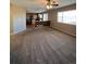 Inviting living room featuring an open layout, neutral carpet, and a seamless transition to the kitchen at 1148 S Duquesne Cir, Aurora, CO 80018