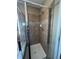 Shower stall with tiled walls and a modern glass door at 1148 S Duquesne Cir, Aurora, CO 80018