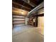 Unfinished basement with shelving, wooden work bench and door at 1148 S Duquesne Cir, Aurora, CO 80018