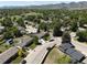 An aerial view of a neighborhood in a suburban community with lush green trees and well-maintained homes at 4382 S Xenon St, Morrison, CO 80465