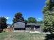 A spacious backyard with a grass area, wood fence, and a view of the mountains in the distance at 4382 S Xenon St, Morrison, CO 80465