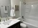 Clean bathroom featuring a modern vanity, shower over tub, and neutral color palette at 4382 S Xenon St, Morrison, CO 80465