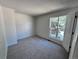 Neutral bedroom with new carpet, and updated board and batten trim with a view of the exterior at 4382 S Xenon St, Morrison, CO 80465
