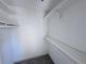 A well-organized walk-in closet with multiple shelves and hanging rods, perfect for maximizing storage at 4382 S Xenon St, Morrison, CO 80465