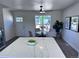 Bright dining area features a ceiling fan, table, and updated finishes near the entry door at 4382 S Xenon St, Morrison, CO 80465