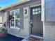 Inviting front entrance with a modern gray door, stylish hardware, and a brick facade at 4382 S Xenon St, Morrison, CO 80465
