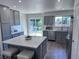 Well-designed kitchen with island, gray cabinets, stainless appliances, and a view of the backyard at 4382 S Xenon St, Morrison, CO 80465