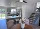 Open floor plan featuring a modern kitchen with island, dining area, and staircase at 4382 S Xenon St, Morrison, CO 80465
