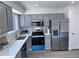 Bright, spacious kitchen with modern gray cabinets, stainless steel appliances, and sleek countertops at 4382 S Xenon St, Morrison, CO 80465