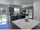 Modern kitchen features gray cabinetry, stainless steel appliances, quartz countertops, and white subway tile at 4382 S Xenon St, Morrison, CO 80465