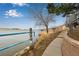 Backyard view of the lake and a path to the waterfront at 6840 Xavier Cir # 5, Westminster, CO 80030