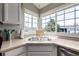 Sunlit kitchen with a stainless steel sink and a large bay window overlooking the neighborhood at 6840 Xavier Cir # 5, Westminster, CO 80030