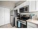 Bright kitchen featuring stainless steel appliances and white cabinetry for a clean, modern look at 6840 Xavier Cir # 5, Westminster, CO 80030