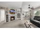 Cozy living room featuring a stone fireplace, mounted TV, and a view into the kitchen at 6840 Xavier Cir # 5, Westminster, CO 80030