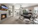 Comfortable living room with modern fireplace, TV, and view into bright, updated kitchen at 6840 Xavier Cir # 5, Westminster, CO 80030