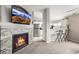 Open-concept living room with a fireplace, modern kitchen, and breakfast bar seating at 6840 Xavier Cir # 5, Westminster, CO 80030