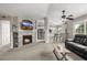 Cozy living room features a stone fireplace and a view into the modern kitchen with breakfast bar at 6840 Xavier Cir # 5, Westminster, CO 80030