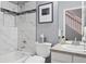 A clean bathroom with a tiled shower/tub combo, vanity, and modern fixtures at 7524 Pineridge Trl, Castle Pines, CO 80108