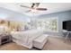 A serene bedroom featuring a king bed, neutral tones, and soft lighting for a relaxing atmosphere at 7524 Pineridge Trl, Castle Pines, CO 80108