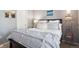 Comfortable bedroom with a queen bed, soft blue bedding, and decorative pillows at 7524 Pineridge Trl, Castle Pines, CO 80108