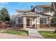 Charming townhouse entrance featuring stone accents, well-maintained landscaping, and a welcoming front door at 7524 Pineridge Trl, Castle Pines, CO 80108