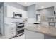 A modern kitchen with granite counters, stainless steel appliances, and white subway tile backsplash at 7524 Pineridge Trl, Castle Pines, CO 80108