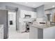 Modern kitchen featuring stainless steel appliances, granite countertops, and white cabinets at 7524 Pineridge Trl, Castle Pines, CO 80108