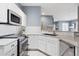 A well-equipped kitchen with stainless steel appliances, a stylish faucet, and ample counter space at 7524 Pineridge Trl, Castle Pines, CO 80108