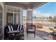 Cozy porch with wicker furniture seating and beautiful community views at 7524 Pineridge Trl, Castle Pines, CO 80108