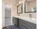 Modern bathroom with dual sinks, sleek vanities, dark tile floors, and contemporary fixtures provides style and functionality at 2552 E 126Th Way, Thornton, CO 80241