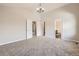 Spacious bedroom with plush carpeting, neutral walls, ample closet space, and an ensuite bathroom offers comfort and convenience at 2552 E 126Th Way, Thornton, CO 80241