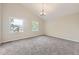 Bright, carpeted bedroom featuring a vaulted ceiling, neutral walls, and two windows offering ample natural light at 2552 E 126Th Way, Thornton, CO 80241