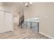 Hallway featuring open staircase with black railings and light wood floors at 2552 E 126Th Way, Thornton, CO 80241
