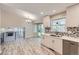 Bright, updated kitchen with modern appliances, sleek cabinets, and a mosaic backsplash, open to the dining area at 2552 E 126Th Way, Thornton, CO 80241