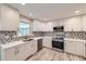Stylish kitchen features stainless steel appliances, modern cabinets, and patterned backsplash at 2552 E 126Th Way, Thornton, CO 80241