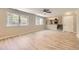 Bright living room featuring large windows, light floors, and an open layout with views of the upper level at 2552 E 126Th Way, Thornton, CO 80241