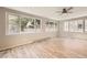 Light-filled living room with stunning hardwood floors and multiple windows providing abundant natural light at 2552 E 126Th Way, Thornton, CO 80241