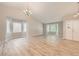 Open living space with large windows offering ample natural light and a chandelier at 2552 E 126Th Way, Thornton, CO 80241