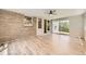 This sun room has wood floors, a brick wall, and glass doors with access to the backyard at 2552 E 126Th Way, Thornton, CO 80241