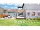 Spacious backyard featuring patio, deck, and lush lawn; ideal for outdoor activities at 9437 E 51St Dr, Denver, CO 80238