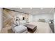Finished basement features a cozy seating area, and work out area through barn doors at 9437 E 51St Dr, Denver, CO 80238