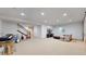 Spacious finished basement with sitting area and stairway at 9437 E 51St Dr, Denver, CO 80238