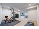 Basement workout room with exercise equipment and rubber floor at 9437 E 51St Dr, Denver, CO 80238