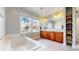 Bright bathroom featuring a soaking tub, a large vanity, and a tiled floor at 9437 E 51St Dr, Denver, CO 80238
