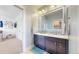 Bright bathroom with double vanity, mosaic backsplash, and tile floors at 9437 E 51St Dr, Denver, CO 80238