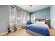 Cozy bedroom with a desk, guitars and lots of natural light from windows with wood blinds at 9437 E 51St Dr, Denver, CO 80238