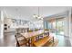 Open-concept dining area with large table, chairs, and sliding doors to the backyard patio at 9437 E 51St Dr, Denver, CO 80238