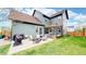 Rear exterior of home with patio, deck, and landscaped backyard; great for entertaining at 9437 E 51St Dr, Denver, CO 80238