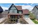 Beautiful two-story home featuring a covered front porch and landscaped front yard at 9437 E 51St Dr, Denver, CO 80238
