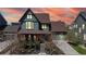 Inviting two-story home with a covered porch, professional landscaping, and an attached two-car garage at 9437 E 51St Dr, Denver, CO 80238